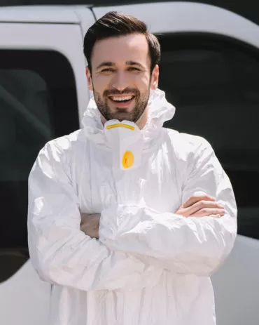 happy pest control worker in uniform standing with