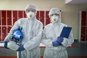portrait of two woman in disinfection suits ready for disinfection